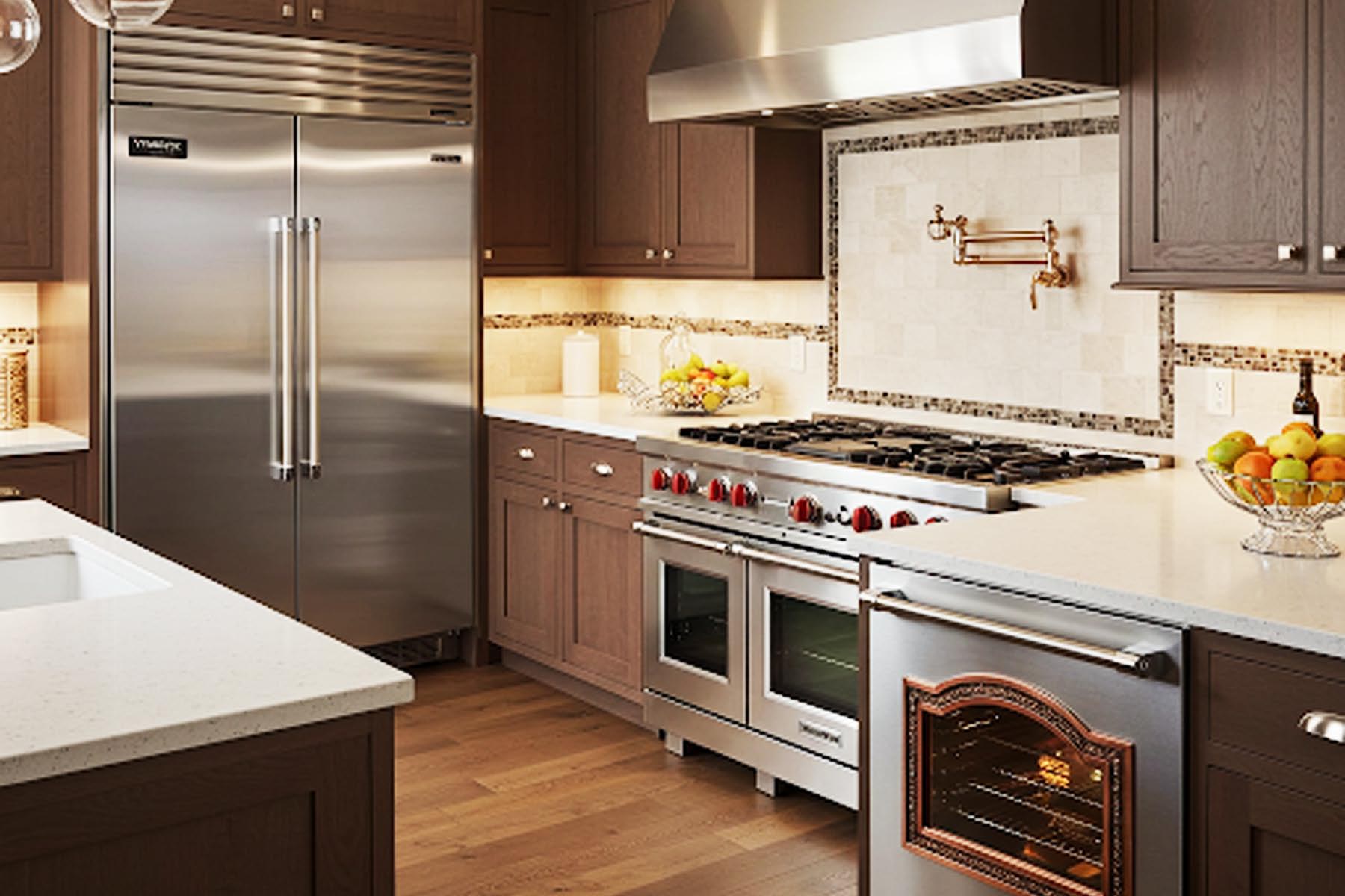 Image of a high end kitchen, containing a full set of luxury appliances, including a refrigerator, oven, and range in Dripping Springs TX