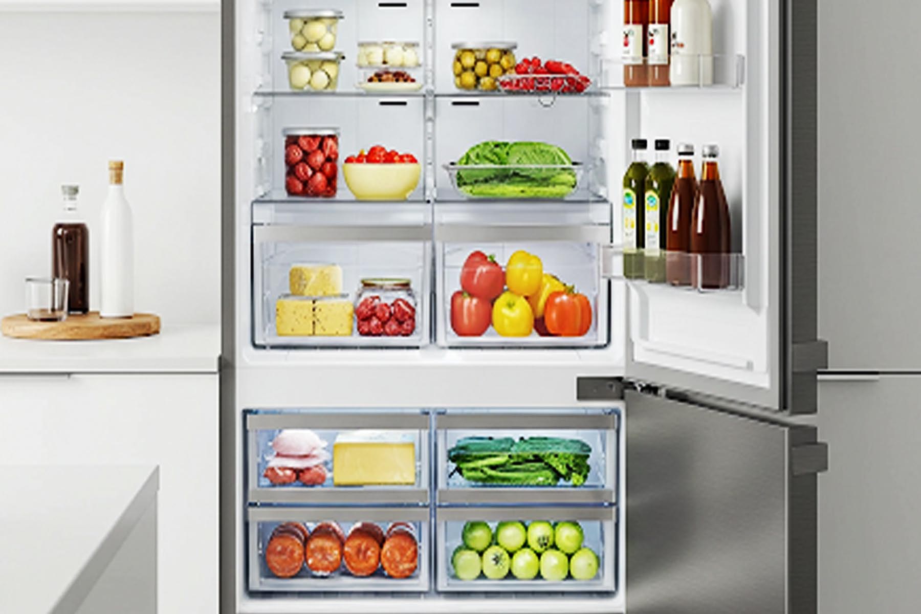 A close-up view of a multi-zone refrigerator drawer with adjustable humidity settings. The drawer is filled with fresh produce, including fruits and vegetables in Georgetown TX
